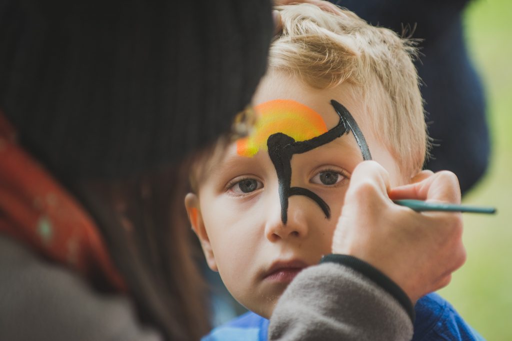 'A' having his face painted